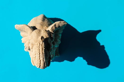 elephant statuette with a hard shadow on a plain background. the view from the top. blank for the pattern