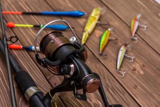 Fishing tackle - fishing spinning, hooks and lures on wooden bac