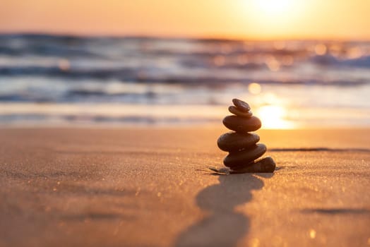 Stones Balance in sunrise at sea in summer.