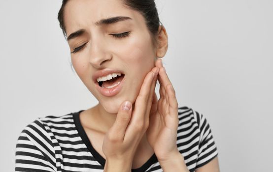 woman holding face health problems teeth pain medicine