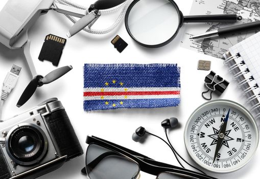 Flag of Cape Verde and travel accessories on a white background.