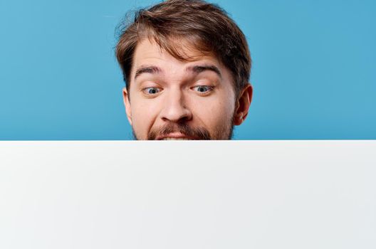 emotional man holding banner ad copy space blue background