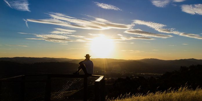 Young man is looking at the sunset, New South Wales, Australia
