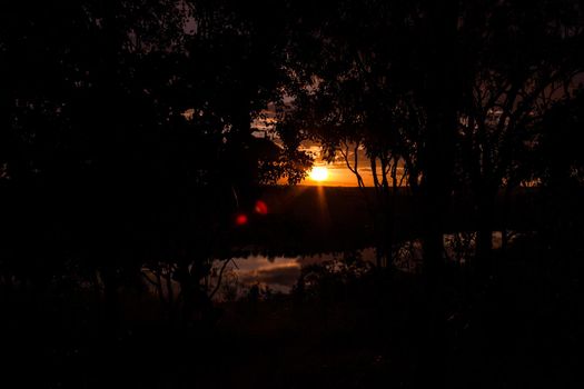 shot through tress of a beautiful sunset in the australian outback with 1 lakes, Nitmiluk National Park, Australia