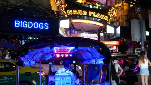 BANGKOK, THAILAND,13 JULY 2019 Vivid neon sign glowing, Nana Plaza street. Nightlife in erotic Red light district soi. Illuminated bar and adult go-go show club. Night life tourist entertainment