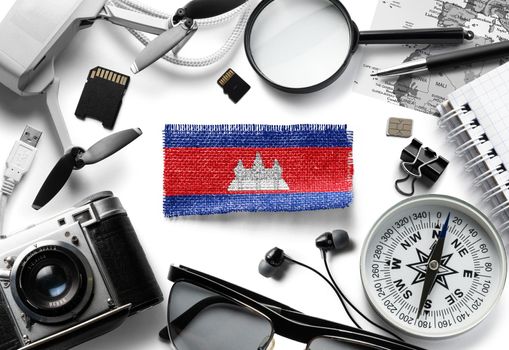Flag of Cambodia and travel accessories on a white background.