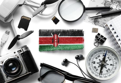Flag of Kenya and travel accessories on a white background.