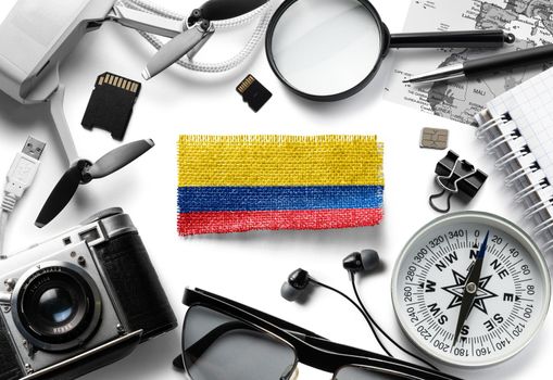 Flag of Colombia and travel accessories on a white background.