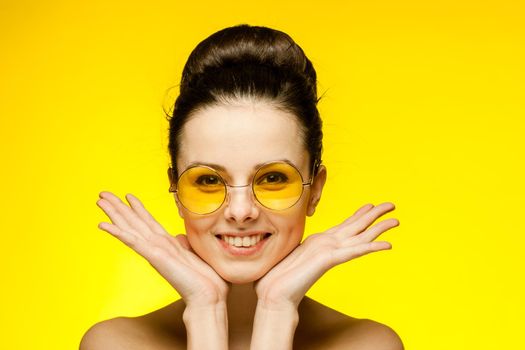 brunette with bare shoulders yellow glasses emotions cropped view studio