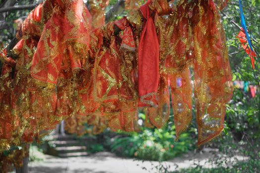 Red cloth wrapped around blessing tree in hinduism temple