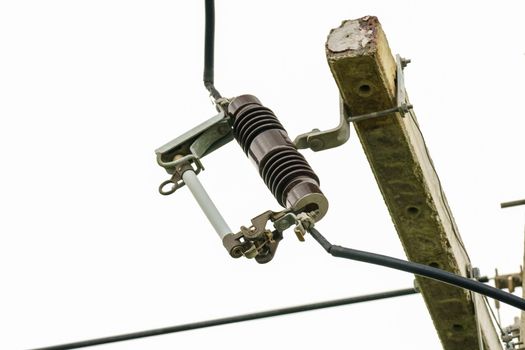 Drop fuse on high-voltage electrical pole supply.