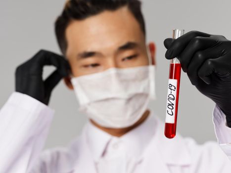 Asian male protective mask black gloves blood biochemistry covid-19