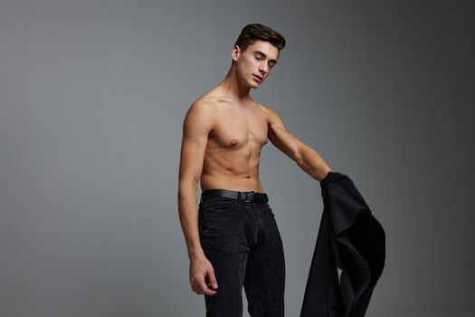 Handsome man nude torso black jacket posing self confidence lifestyle charm