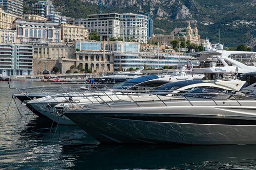 Monaco, Monte-Carlo, 06 August 2018: Tranquillity in port Hercules, is the parked boats, sunny day, many yachts and boats, a lot of Rivas boats, megayachts, massif of expensive real estate
