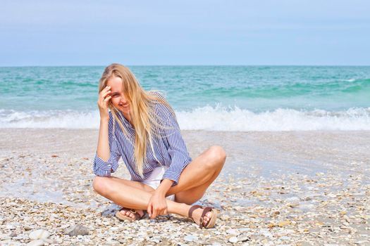 Beautiful happy girl on the Adriatic beach. Travel and vacation.