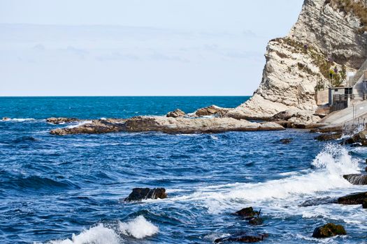 Blue sea water, stones and rocks on Adriatic sea coast.