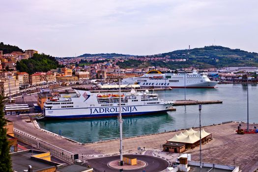 Ancona, Italy - June 8, 2019: The harbor of Ancona with cruise liner ships and boats docked and ancient city view.