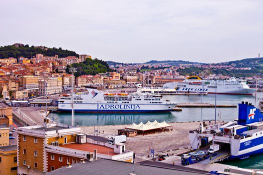 Ancona, Italy - June 8, 2019: The harbor of Ancona with cruise liner ships and boats docked and ancient city view.
