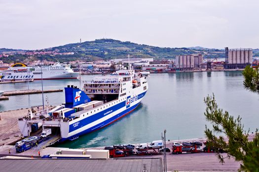 Ancona, Italy - June 8, 2019: The harbor of Ancona with cruise liner ships and boats docked and city view.