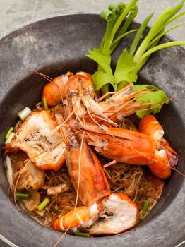 Baked king prawn vermicelli with soya sauce in hot pot.