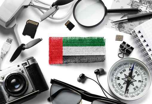 Flag of United Arab Emirates and travel accessories on a white background.