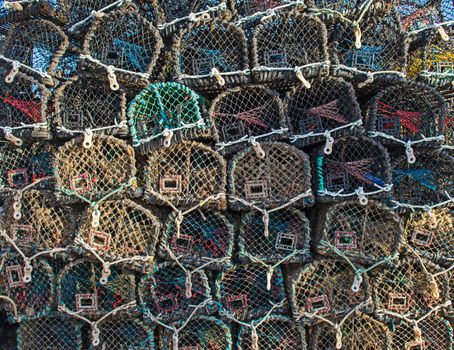 Lobster pots stacked up on a harbor quayside