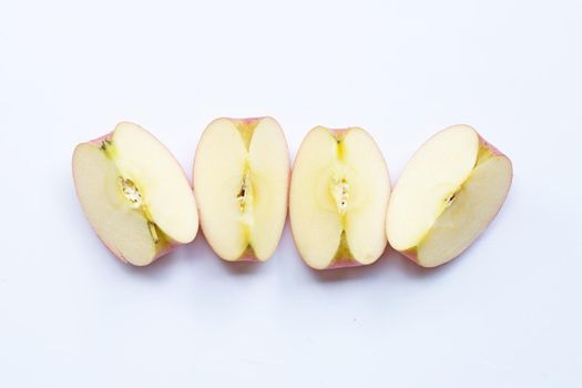 Ripe apple slices on white background.