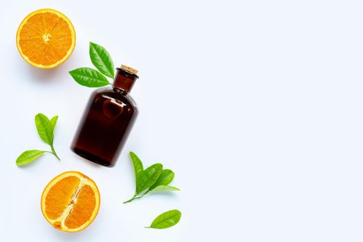 High vitamin C, Fresh orange fruit with essential oil bottle on white background. Copy space