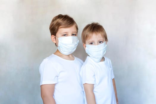 Boys-brothers in medical masks. Coronavirus, disease, infection, quarantine, medical mask, COVID-19. Quarantine and protection from influenza viruses and epidemics covid-19. 