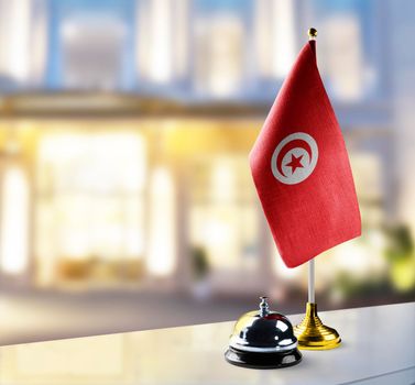 Tunisia flag on the reception desk in the lobby of the hotel