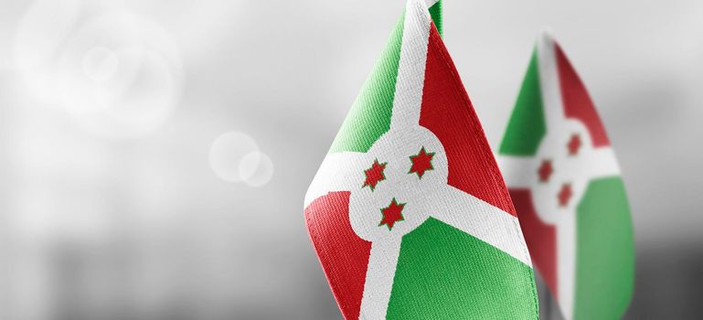 Small national flags of the Burundi on a light blurry background