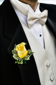 Close-up photo of Yellow Rose on Groom's Tuxedo