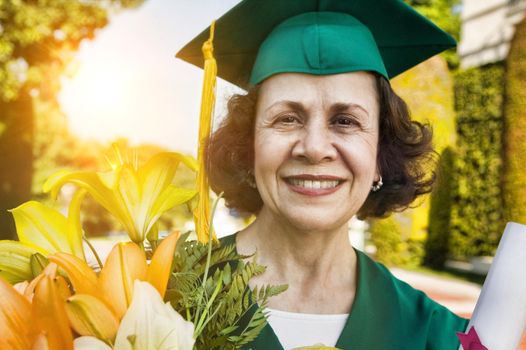 Portrait of Senior woman graduate holding flowers