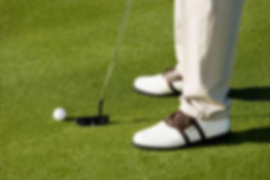 Blurred photo of Golfer Preparing to Putt for Par