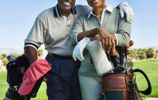 Senior couple golfers in the golf course