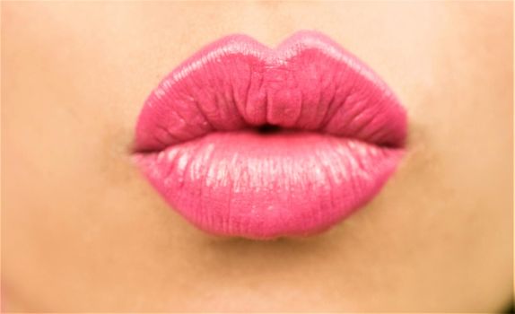 Young woman puckering her pink lips