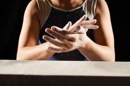 Cropped photo of Young Gymnast with chalk in her hands