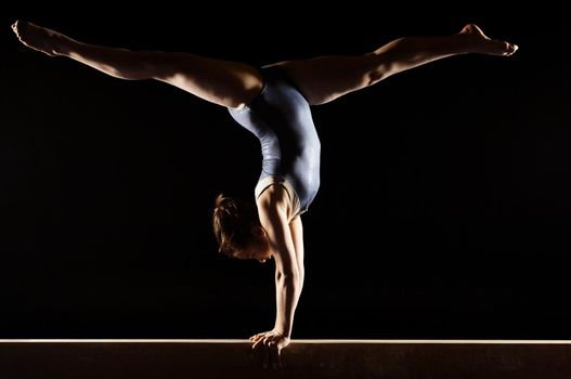 Gymnast Doing Split Handstand on Balance Beam