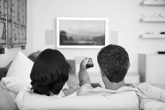 Black and white photo of couple watching television on lockdown