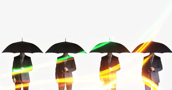 Four businessmen holding umbrellas in a line against white background