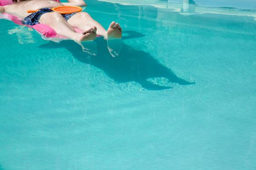 Person floating in pool
