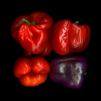 Four withered bell peppers view from above