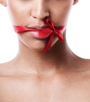 Red bow tied over womans mouth