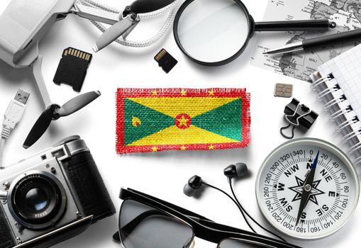 Flag of Grenada and travel accessories on a white background.