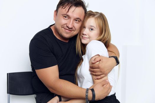 father hugs daughter family studio lifestyle close-up. High quality photo