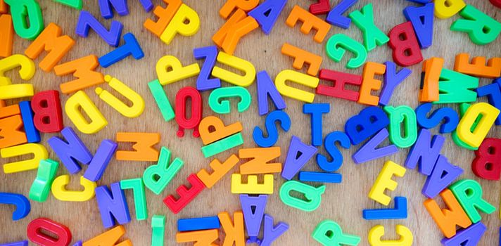 Alphabet learning concept: Close up of toy letters in the kindergarten 