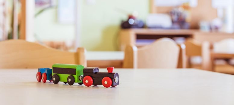 Children development concept: Close up of wooden toy railroad in the kindergarten