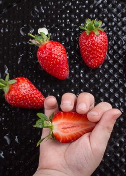 Sweet and ripe strawberry fruit in hand