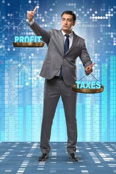 Businessman comparing profit and taxes