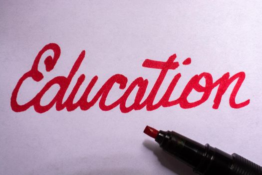 Education word over white paper.  Education word concept for background.